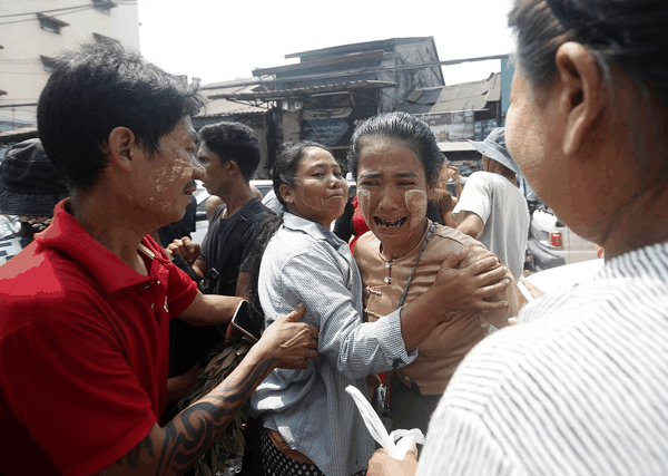 当地时间2026年4月17日，缅甸仰光，一名获释囚犯（中）在永盛监狱外与亲友见面。