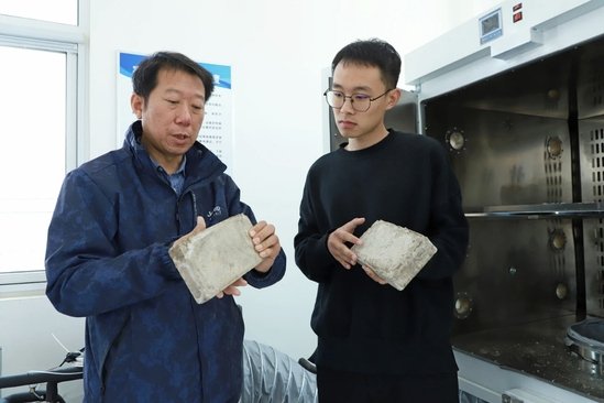 上海理工大学应届硕士生李京阳展示制备的疏浚物砖坯。