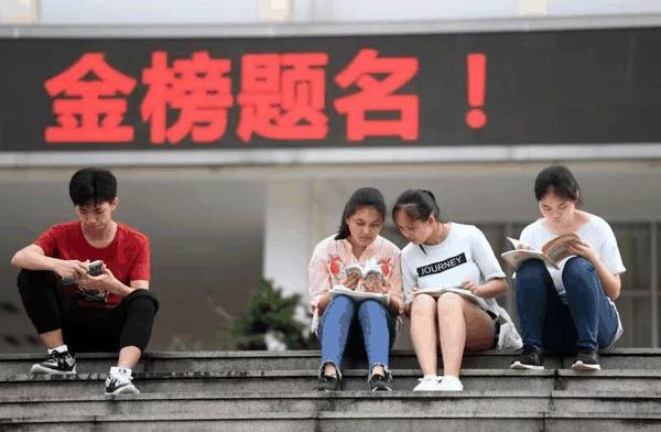 ▲资料图：某高考考点，考生在考场外复习。图/新华社