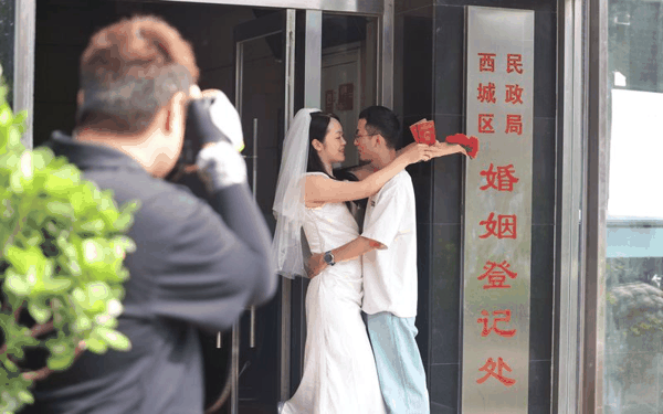 一对新人在西城区民政局婚姻登记处拍照留念。新京报记者 王贵彬 摄